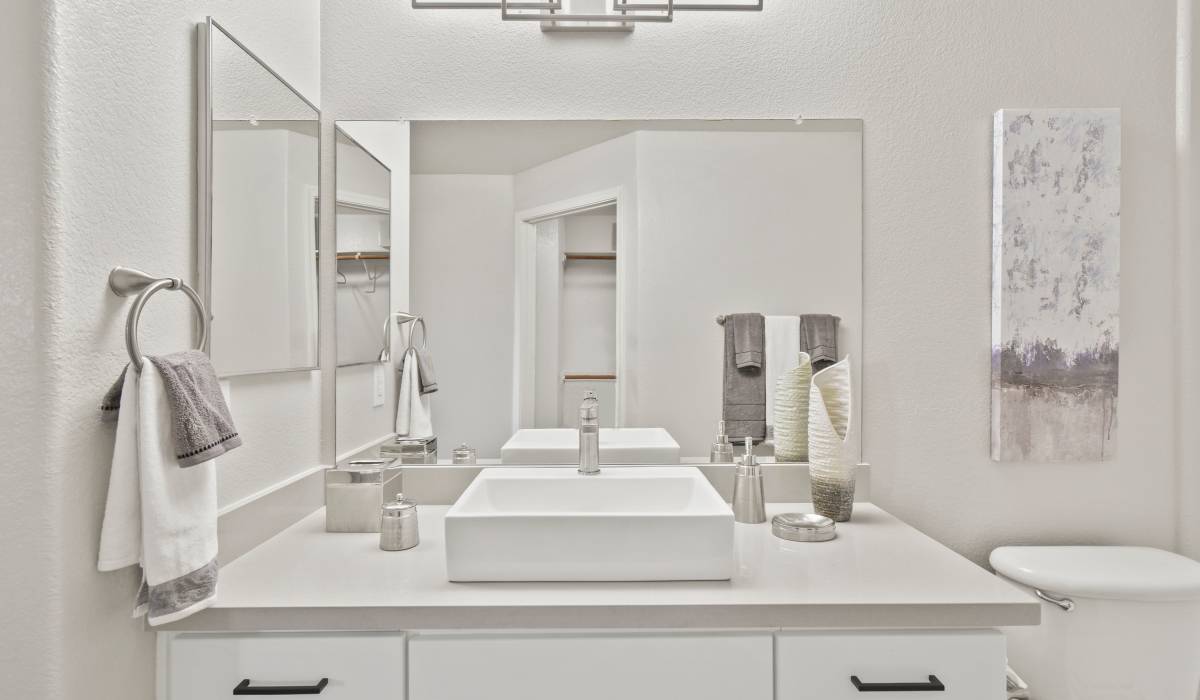 Model bathroom with a large mirror at La Serena at Toscana in Phoenix, Arizona