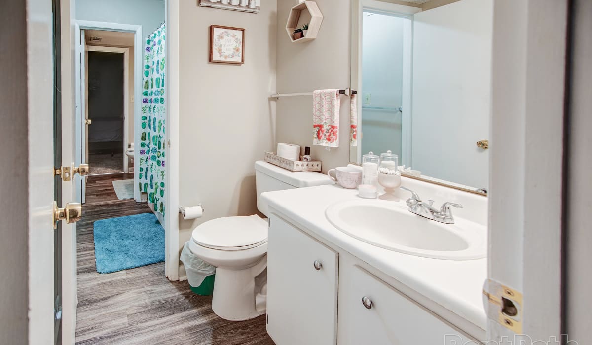Bathroom with wood-style flooring at Ivy Green at the Shoals in Florence, Alabama