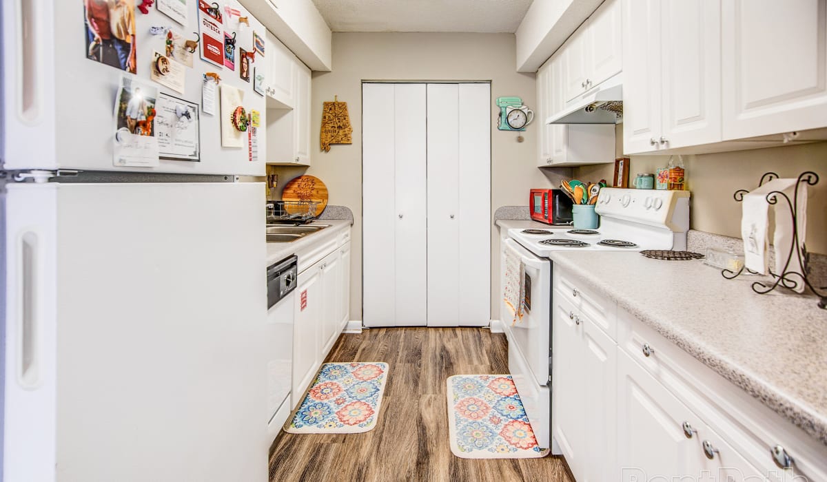 Apartment kitchen with wood-style flooring at Ivy Green at the Shoals in Florence, Alabama