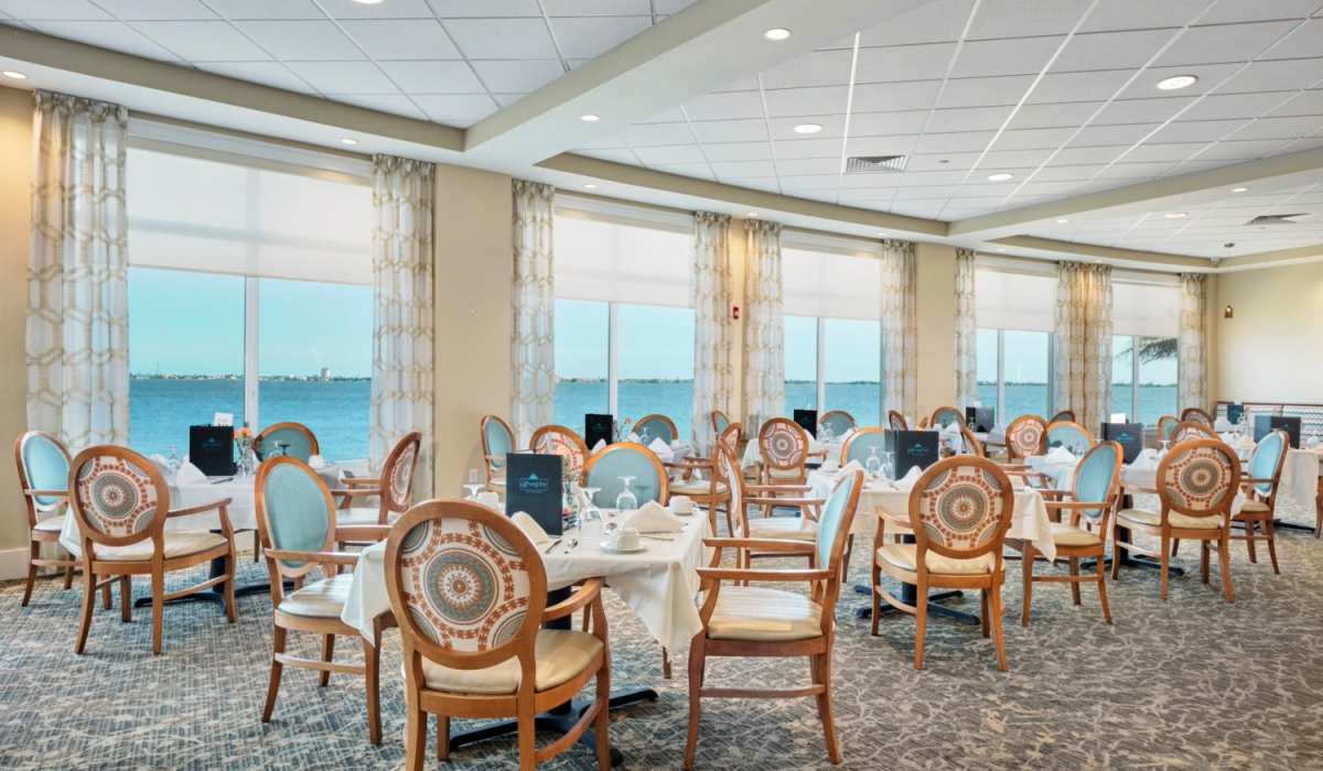 Tables in the community dining rooms at Grand Villa of Palm Bay in Palm Bay, Florida