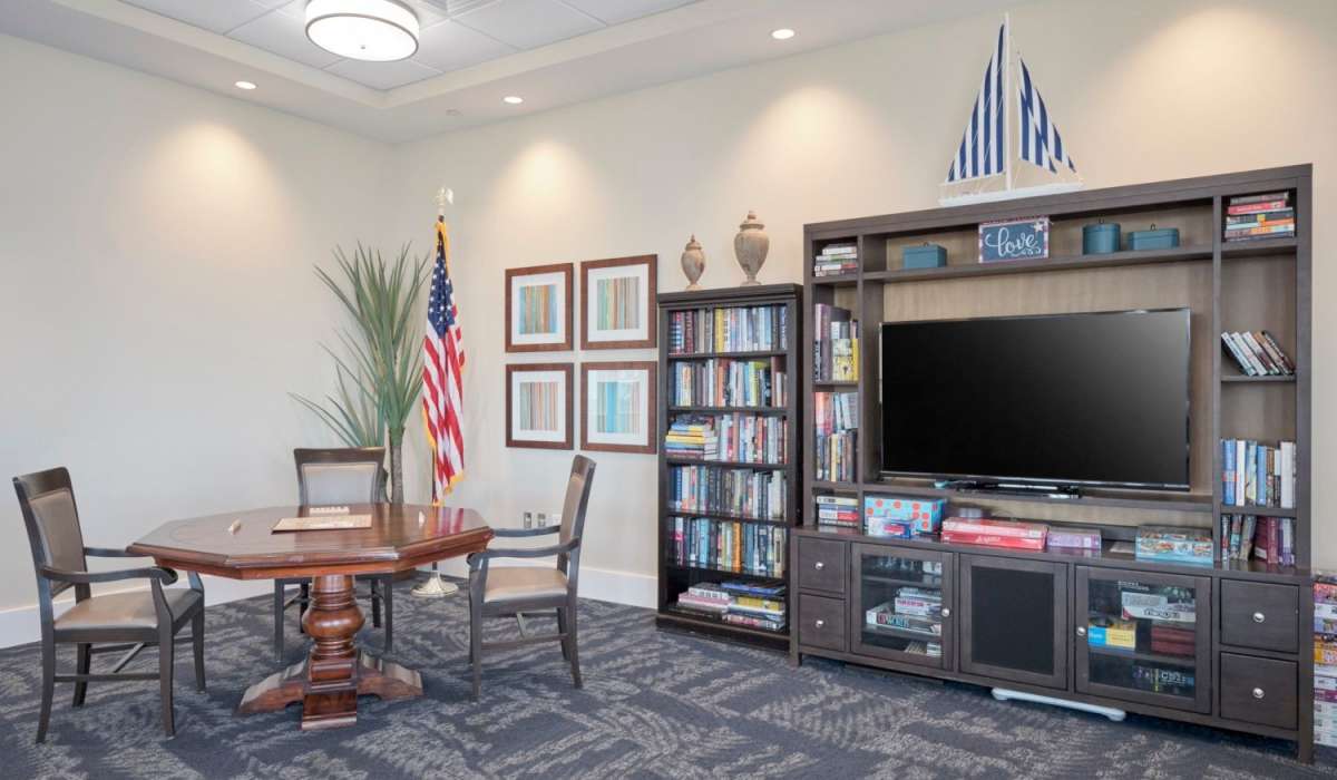 A table and television in an entertainment room at Grand Villa of Palm Bay in Palm Bay, Florida