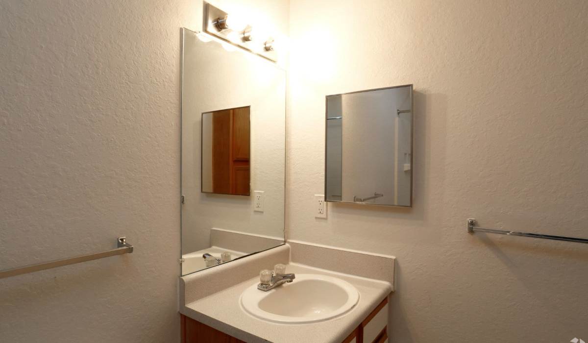 Bathroom with vanity lights at Pebble Brooke Apartments in Milford, Ohio