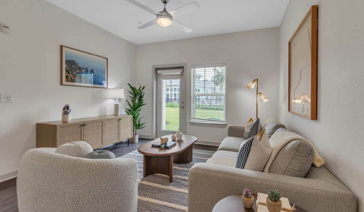 Living room with ceiling fan in a model home at Seaton Preserve in Jacksonville, Florida