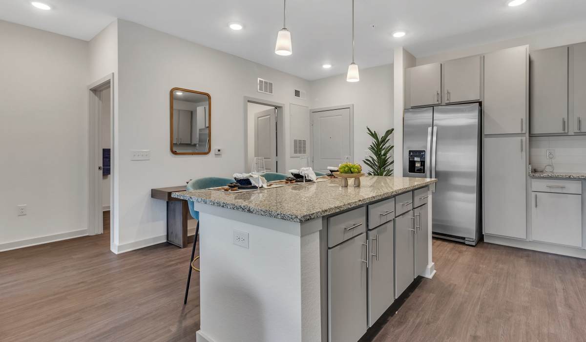 Kitchen with wood flooring and stainless-steel appliances in a model home at Seaton Preserve in Jacksonville, Florida