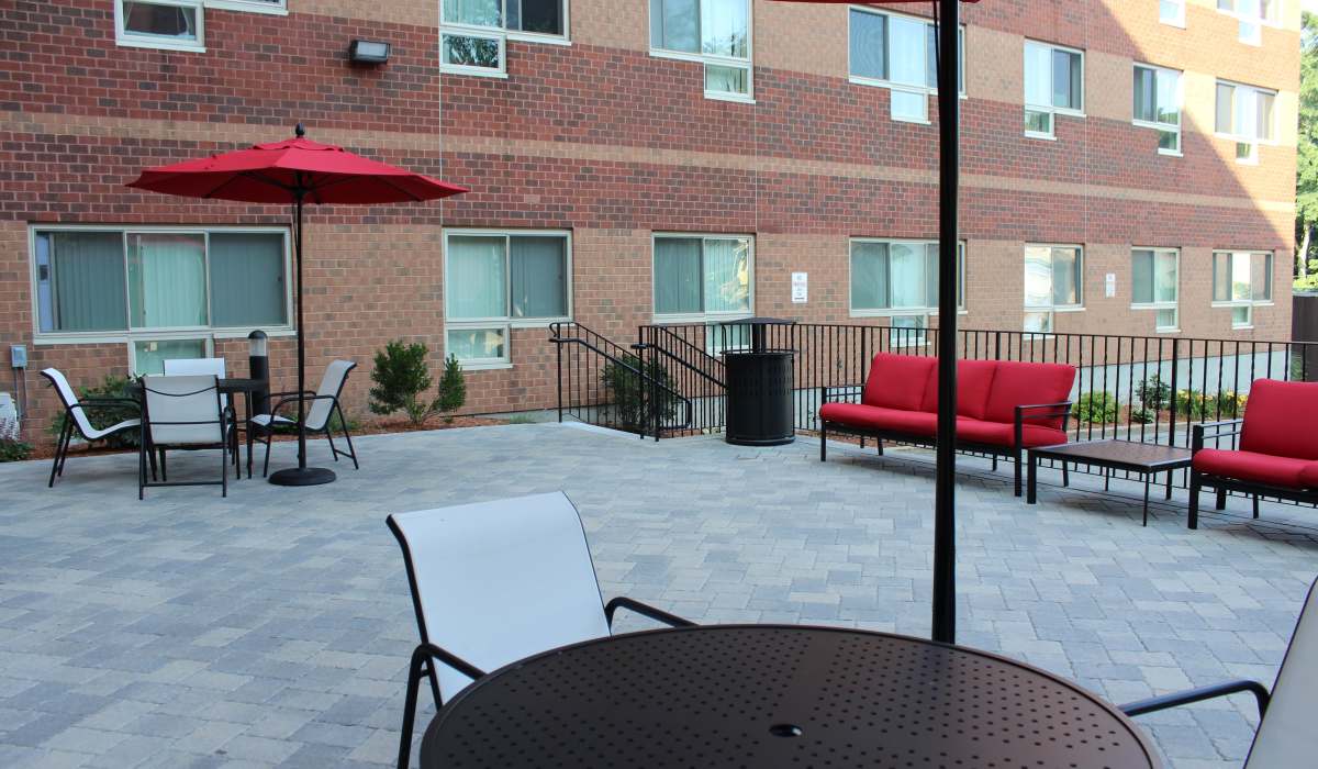Outdoor patio with tables and umbrellas at Station 101 in Beverly, Massachusetts