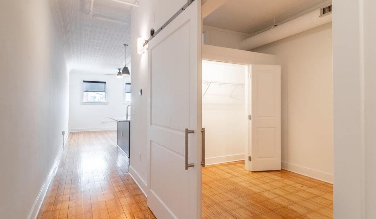 An apartment hallway leading to a bedroom at Landmark at Marshall Broad in Richmond, Virginia