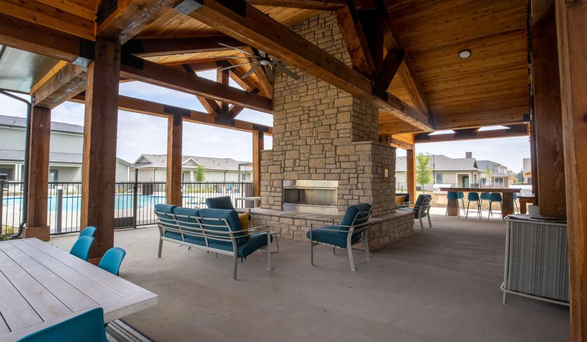 Private patio with fireplace, chairs and tables at Home At Waller in Waller, Texas