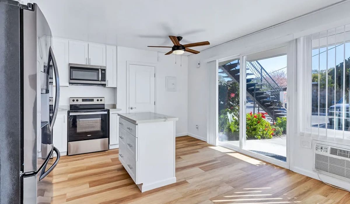 An apartment kitchen and a sliding door to the patio at Silverado Gardens in Napa, California