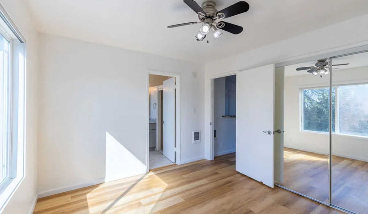 Wood flooring and a ceiling fan in an apartment bedroom at Silverado Gardens in Napa, California