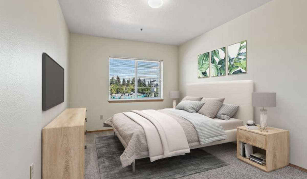 Comfortable bedroom with multiple windows at Ventura Park Plaza Apartments in Portland, Oregon