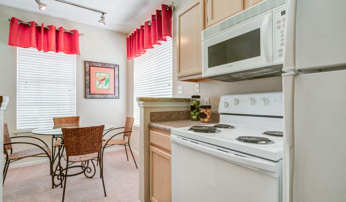 Dining table with a kitchen view at Sole at Citrus Park in Tampa, Florida