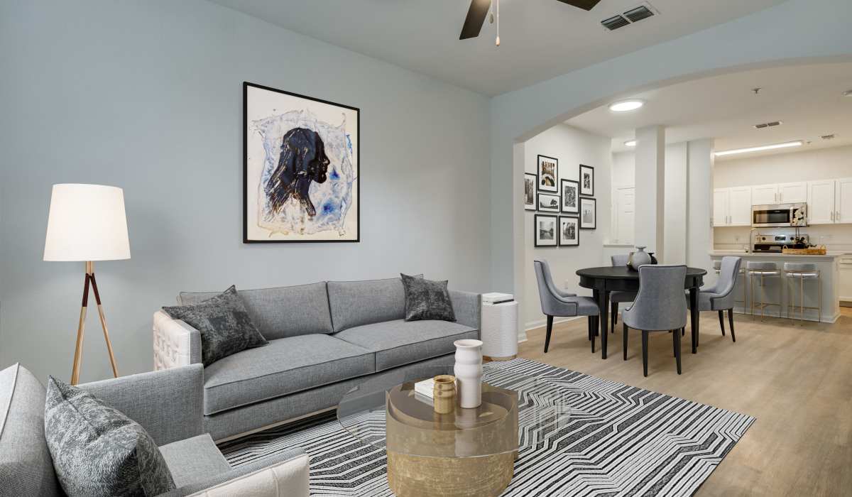 Living room with couches adjacent to the kitchen at Sole at Citrus Park in Tampa, Florida