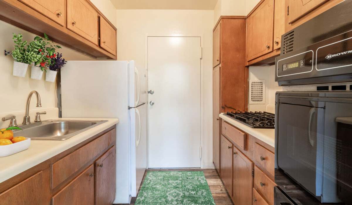 kitchen with wooden cabinets at Three Chopt West Apartments in Henrico, Virginia