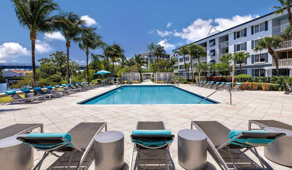 View of pool and lounge chairs at Bermuda Cay in Boynton Beach, Florida