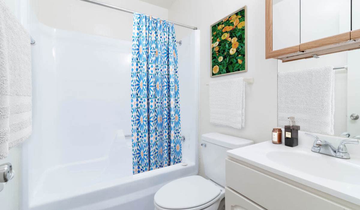 bathroom with blue shower curtain at Southgate Manor in Elizabeth City, North Carolina