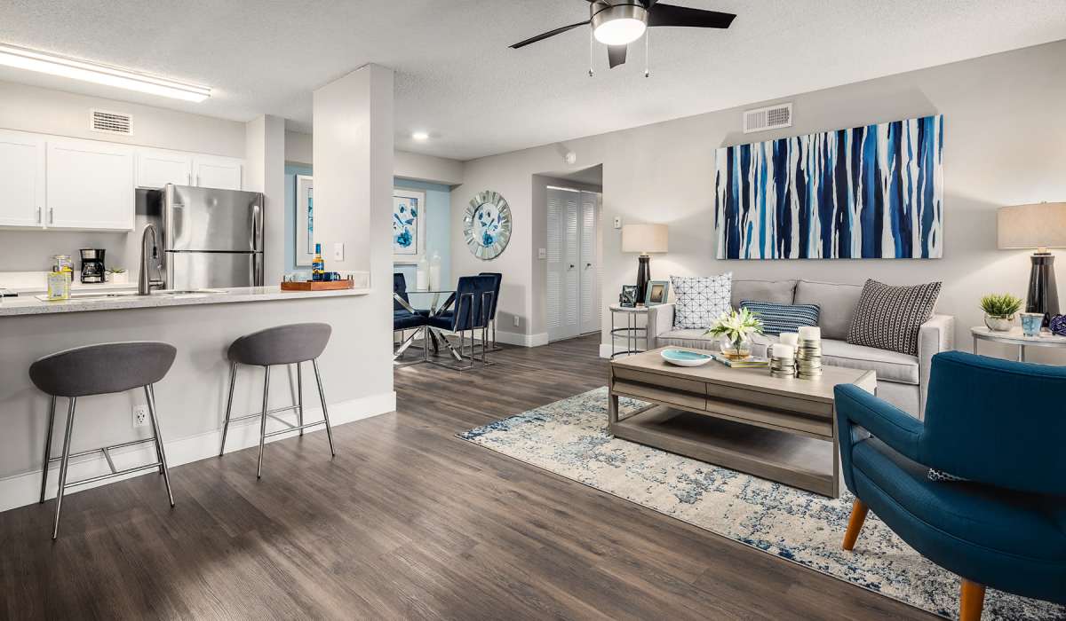 Another view of a model living space with blue accents at Boynton Place Apartments in Boynton Beach, Florida