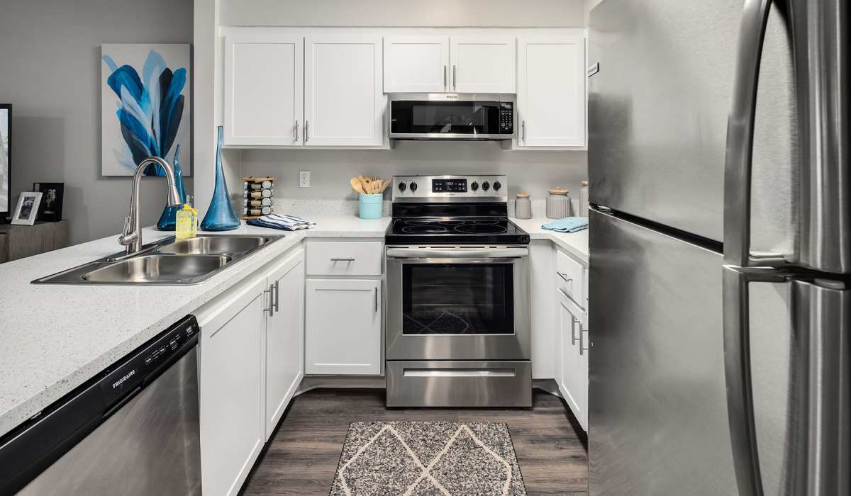 Model kitchen with modern appliances at Boynton Place Apartments in Boynton Beach, Florida