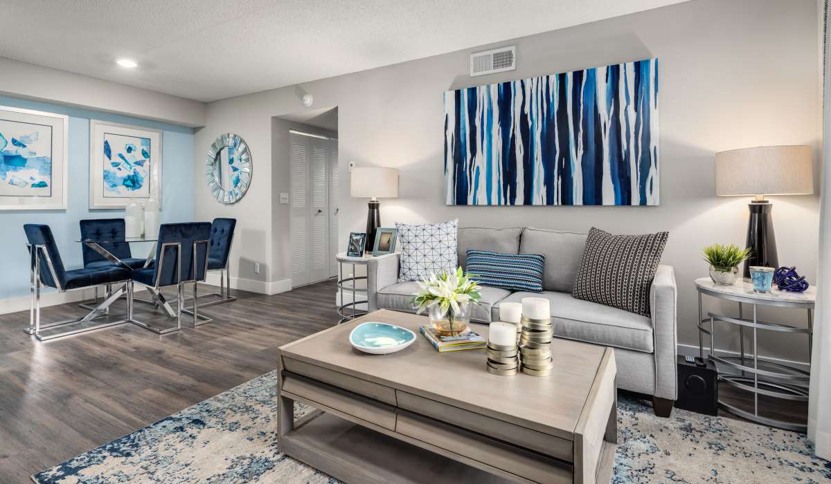Model living space with blue accents at Boynton Place Apartments in Boynton Beach, Florida