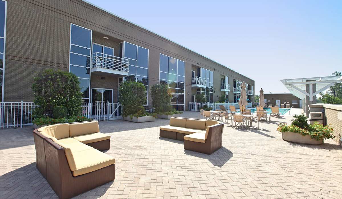 Outdoor sectional couches for residents near the pool at Environs Lofts at East 54 in Chapel Hill, North Carolina