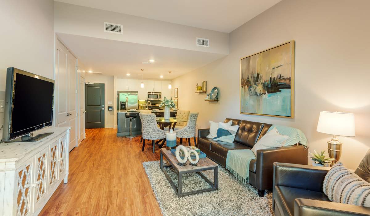 A furnished living room with wood flooring at Environs Lofts at East 54 in Chapel Hill, North Carolina