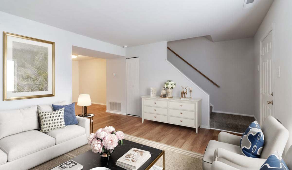 Living room with stairs at Cloverleaf Lake Townhouse Apartments in North Chesterfield, Virginia