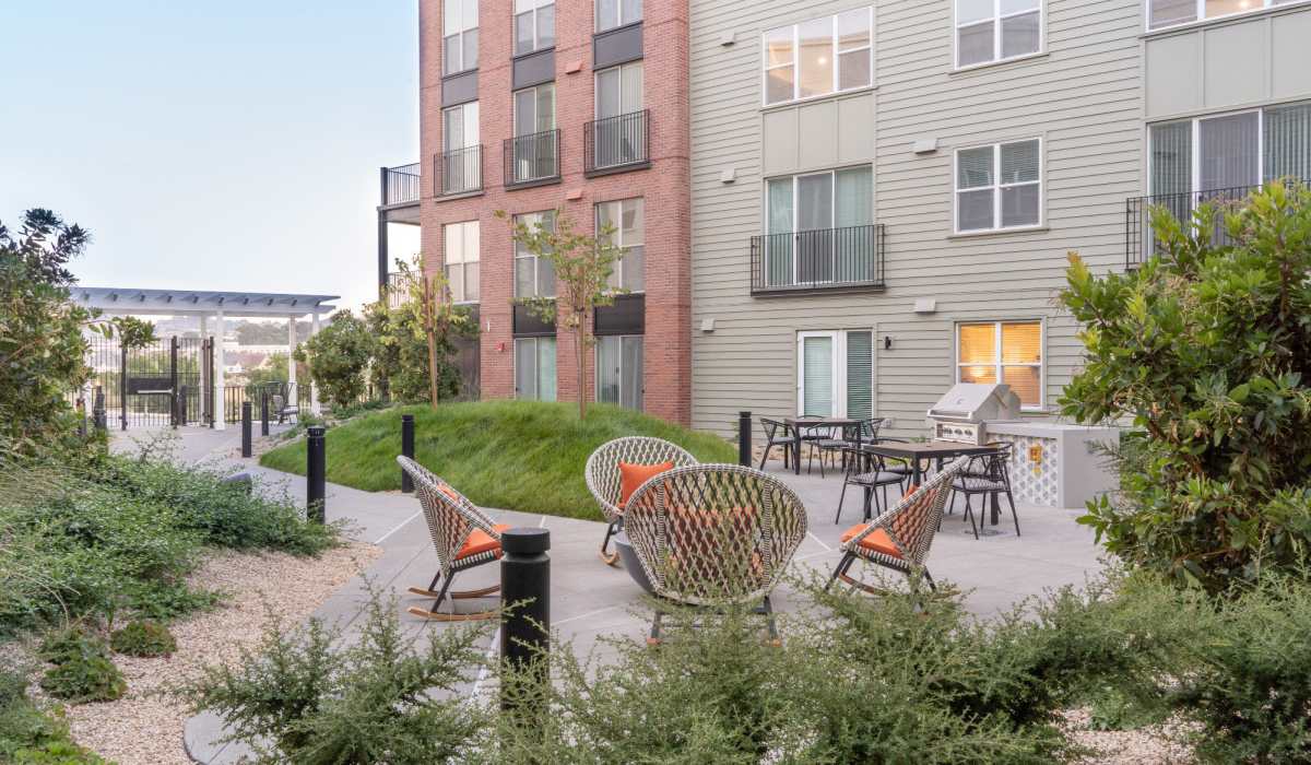 Courtyard seating surrounded by plants at The Grand at Bayfront in Hercules, California