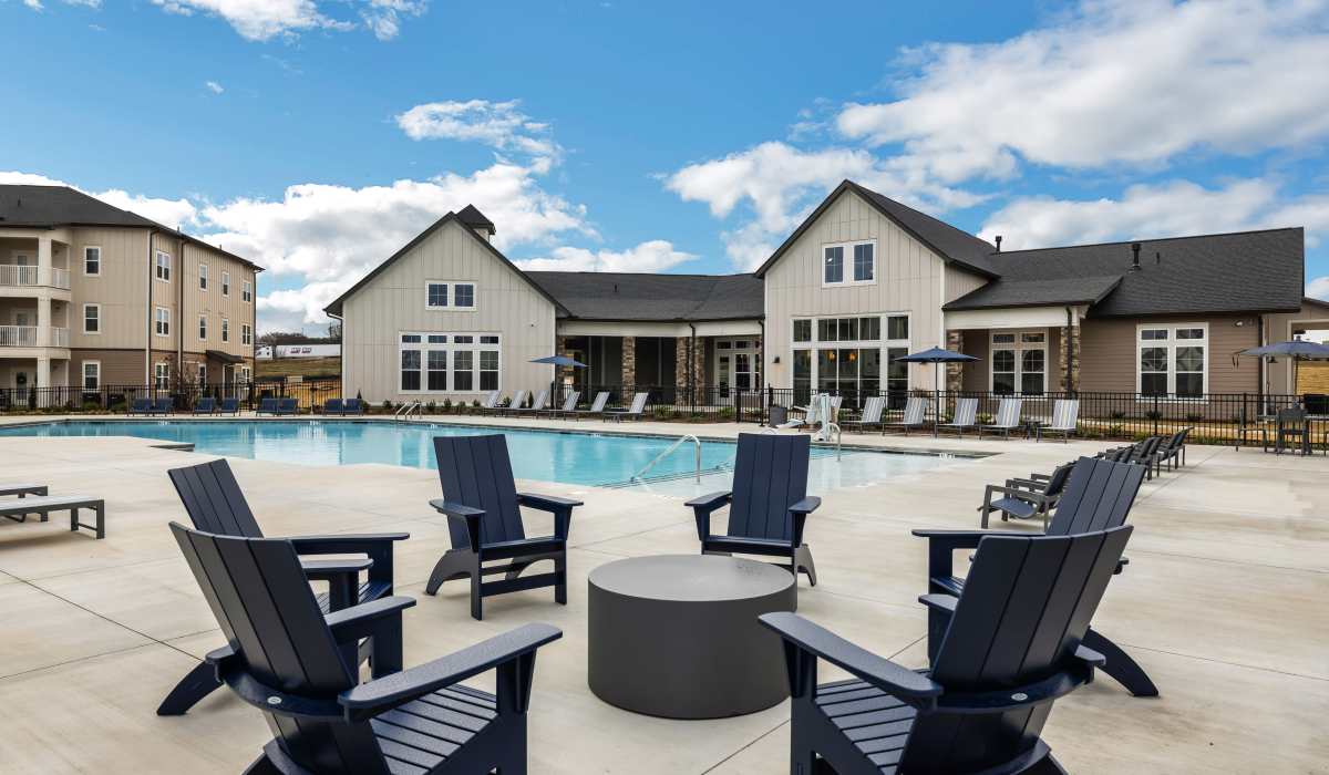 Outdoor lounge chairs and firepit near the swimming pool at The Standard at Pinestone in Travelers Rest, South Carolina