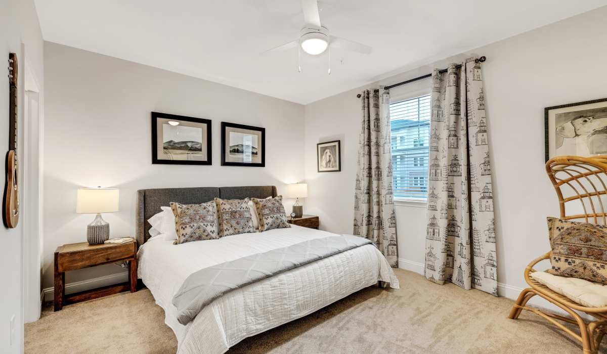 Bedroom with carpeted flooring in a model home at The Standard at Pinestone in Travelers Rest, South Carolina