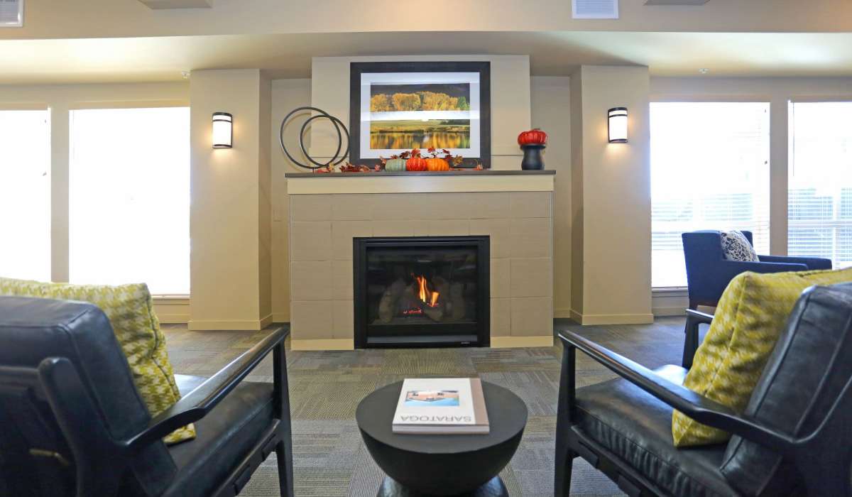 Clubhouse lounge with a fireplace at Traditions at Colorado Springs in Colorado Springs, Colorado