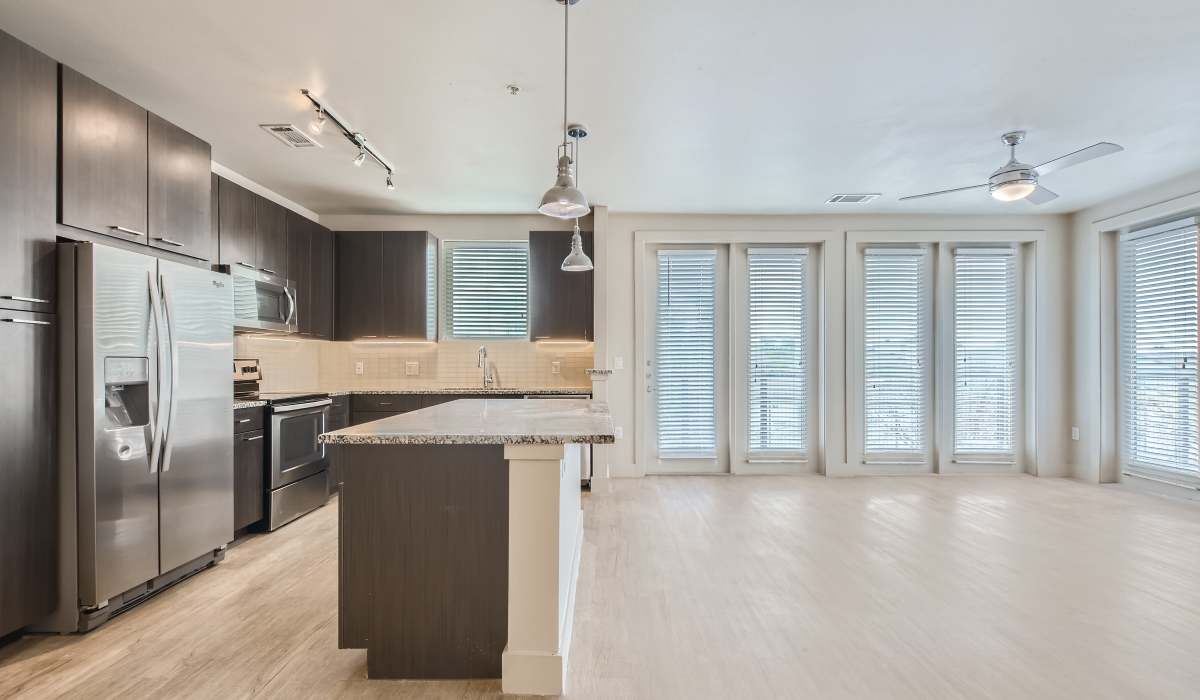 View of spacious living room from kitchen at The Lucas Apartments in Dallas, Texas