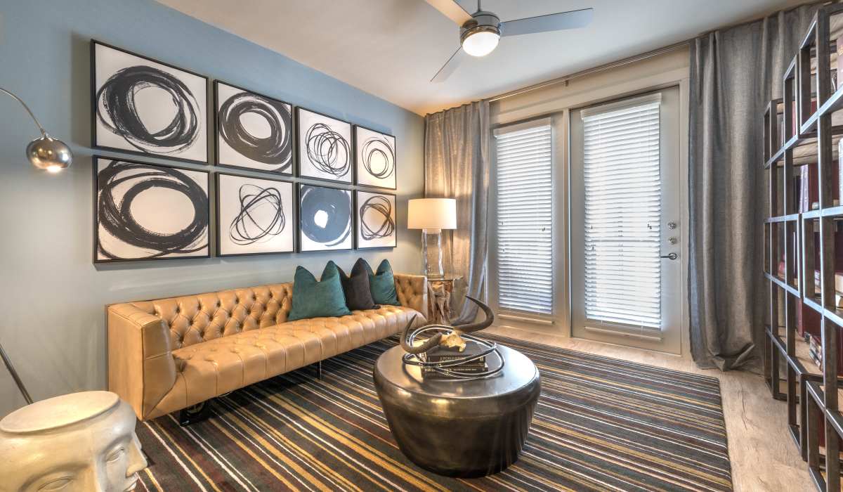 Living room with hard-wood style flooring and plenty of room for a couch and more at The Lucas Apartments in Dallas, Texas