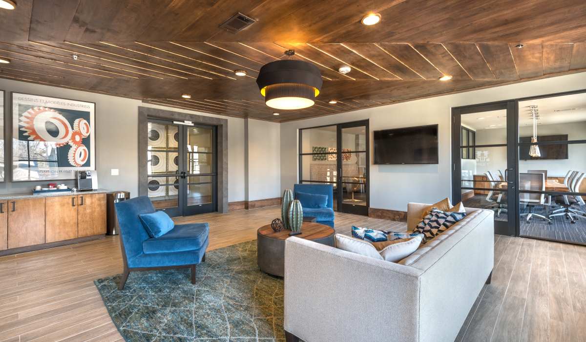 The clubhouse living room with a spacious television for a comfortable gathering space.at The Lucas Apartments in Dallas, Texas