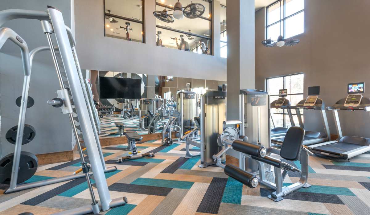 Fully-equipped gym with treadmills, weight machines at The Lucas Apartments in Dallas, Texas