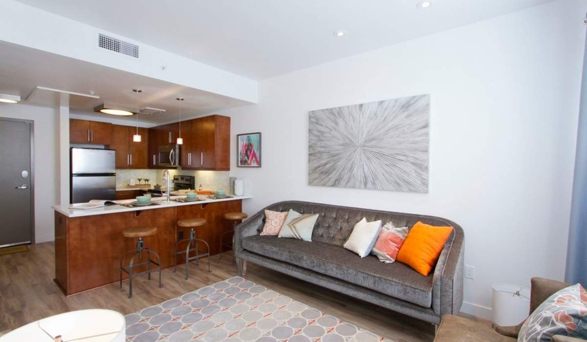 Living room with sofa and wall art at One City Block in Denver, Colorado