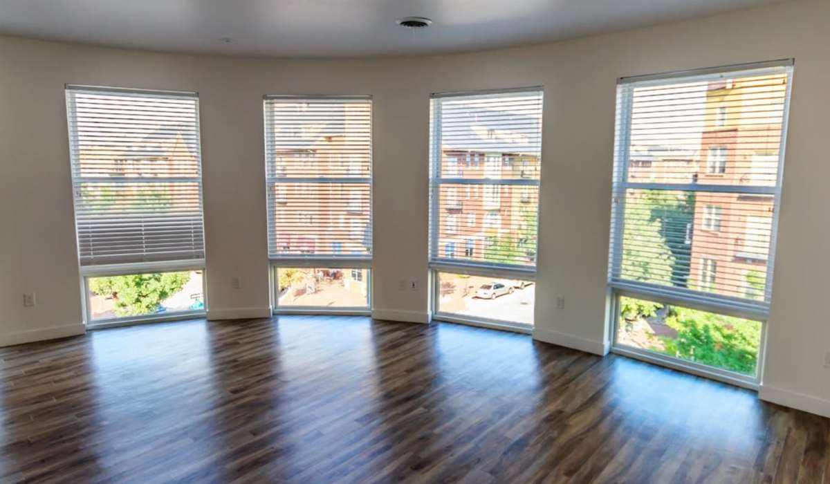 Bright living room with plank-style flooring at One City Block in Denver, Colorado