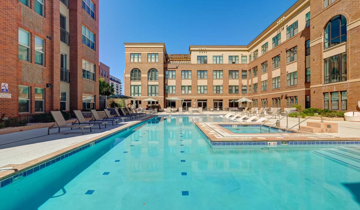 Large swimming pool with lounge chairs at One City Block in Denver, Colorado 