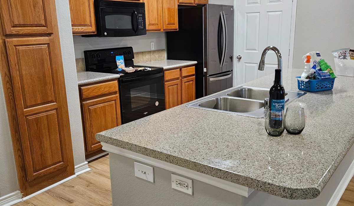 Fully equipped kitchen with bar at Lebanon Ridge in Frisco, Texas