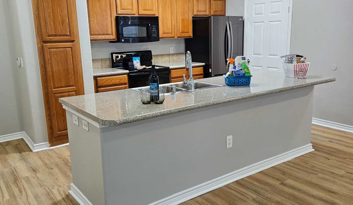 Modern kitchen with wooden flooring at Lebanon Ridge in Frisco, Texas