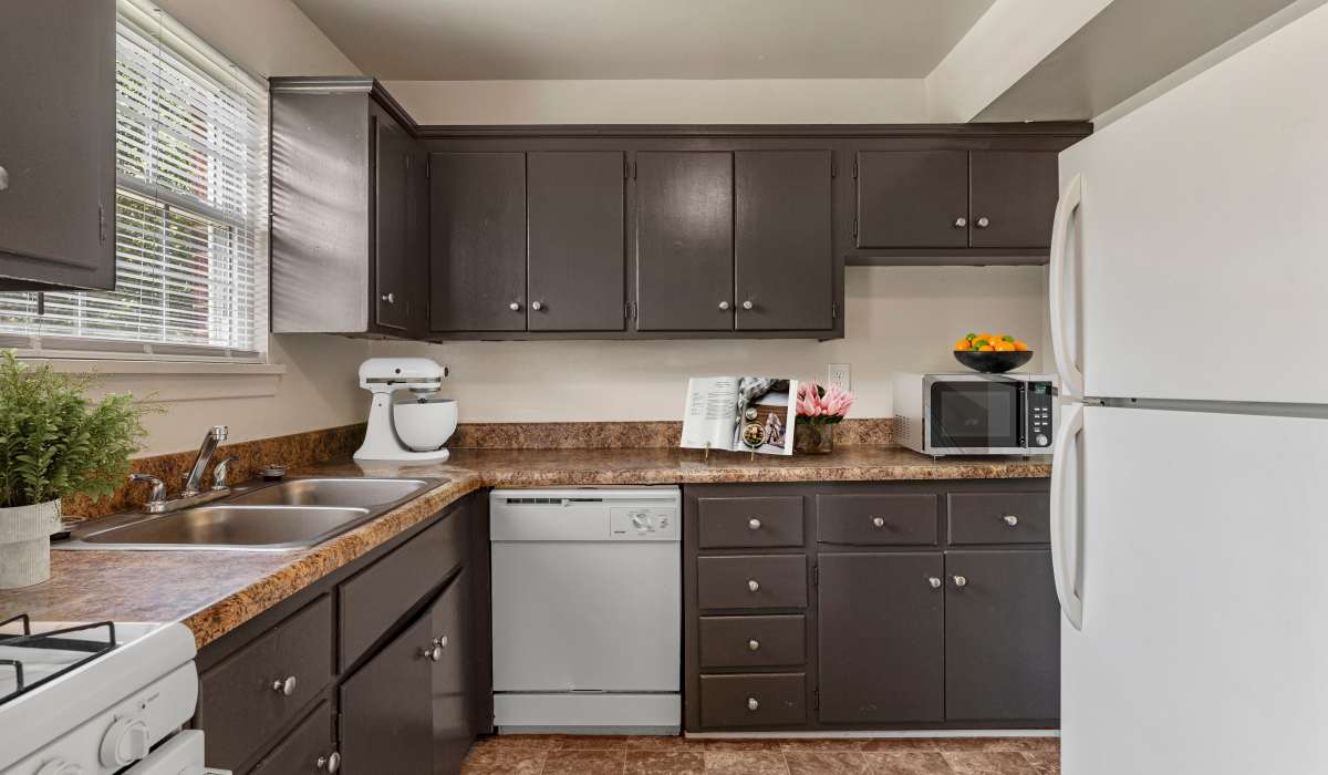 Kitchen with dark wooden cabinets at Landmark at Gayton Apartments in Richmond, Virginia