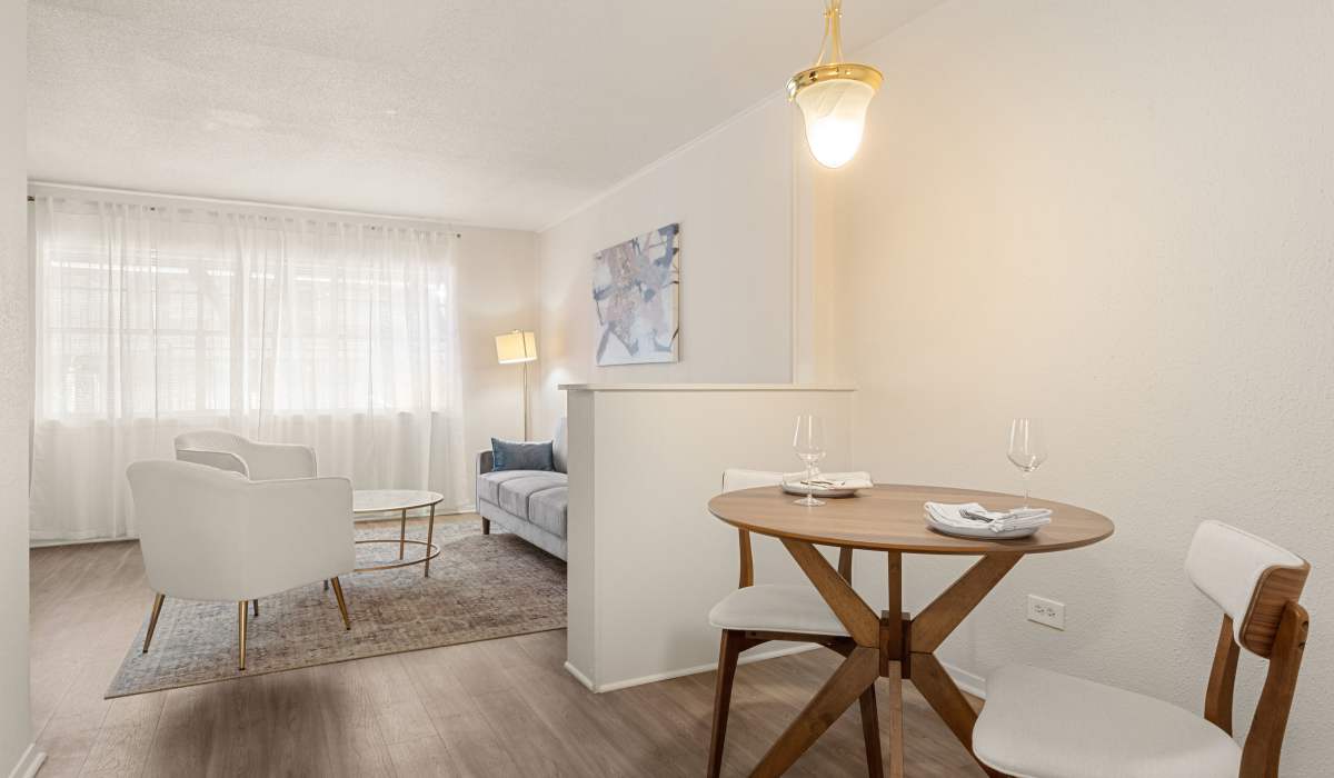 Modern room with dining table and bookshelf at Celeste in Lake Charles, Louisiana