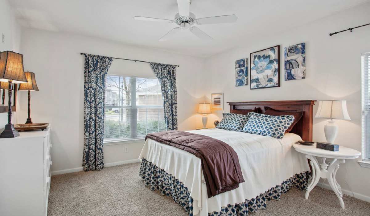 Well-lit bedroom with comfortable bedroom and a large window at Ansley Place in Houma, Louisiana