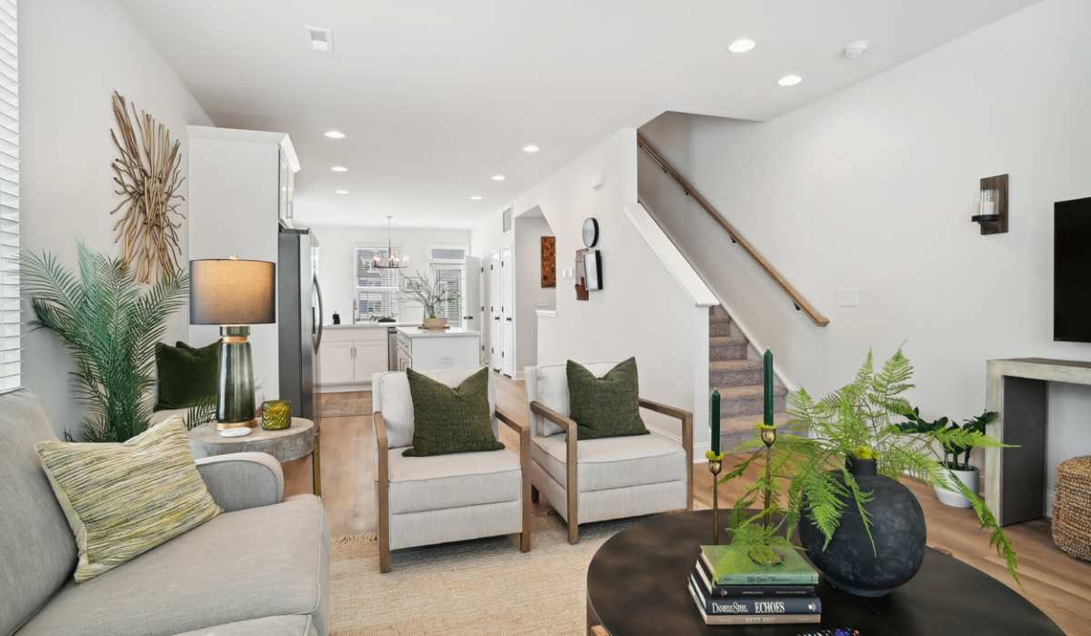 Spacious living room with access to kitchen at Towns At Eastland in Charlotte, North Carolina