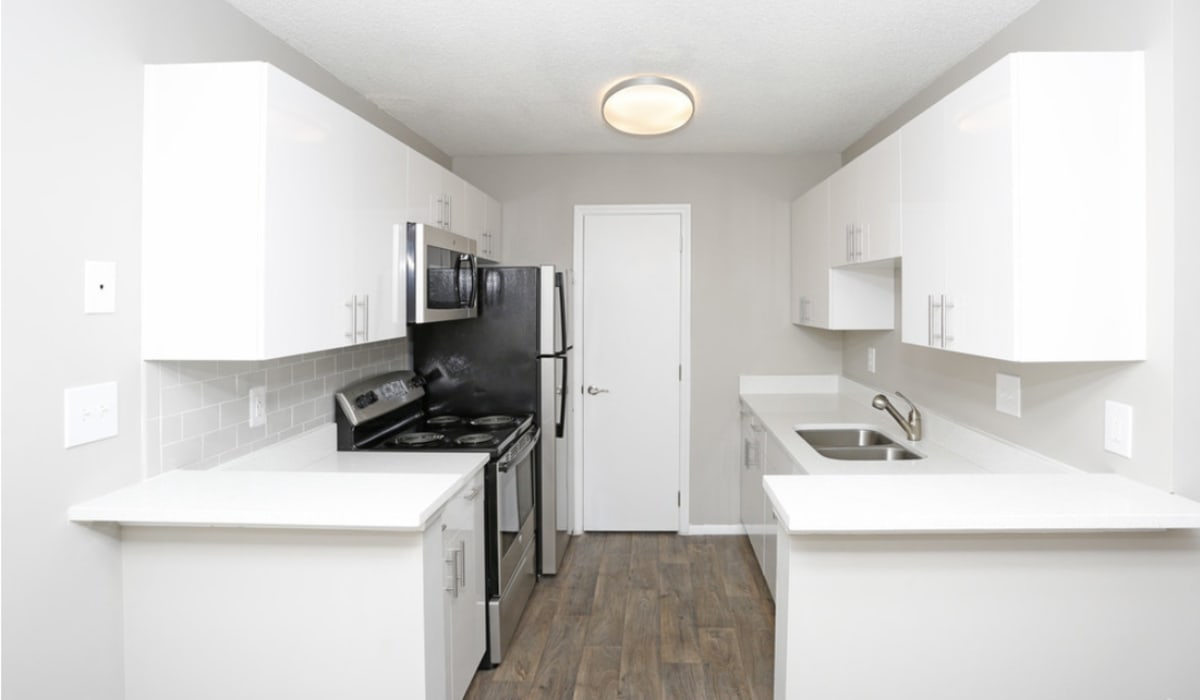 Kitchen with white countertop and cabinetry at Commons at University Square in Charlotte, North Carolina