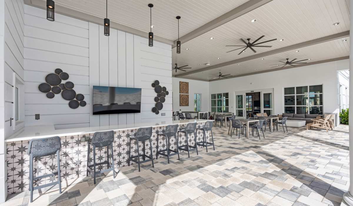 Clubhouse with many tables and chairs at Tredici at Central Park in Port St. Lucie, Florida