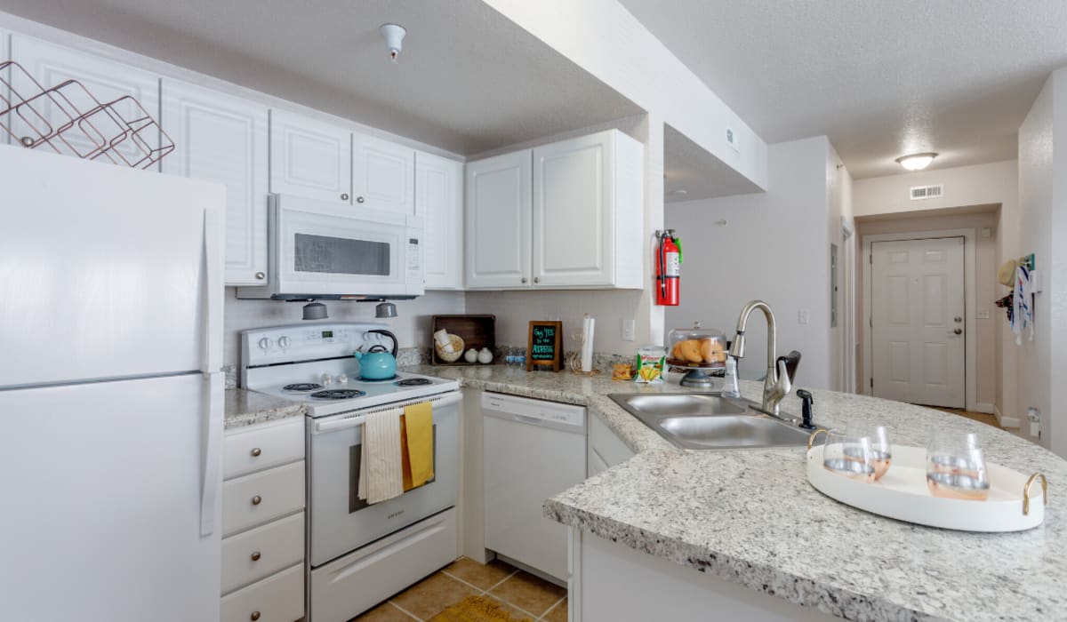 Model kitchen with white walls at The Pointe On College Avenue in Manhattan, Kansas