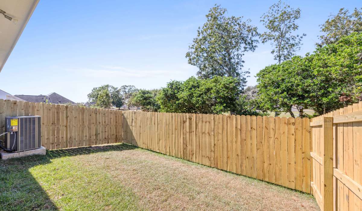Fenced backyard of model home at Cottages at Sugar Mill Pond in Youngsville, Louisiana