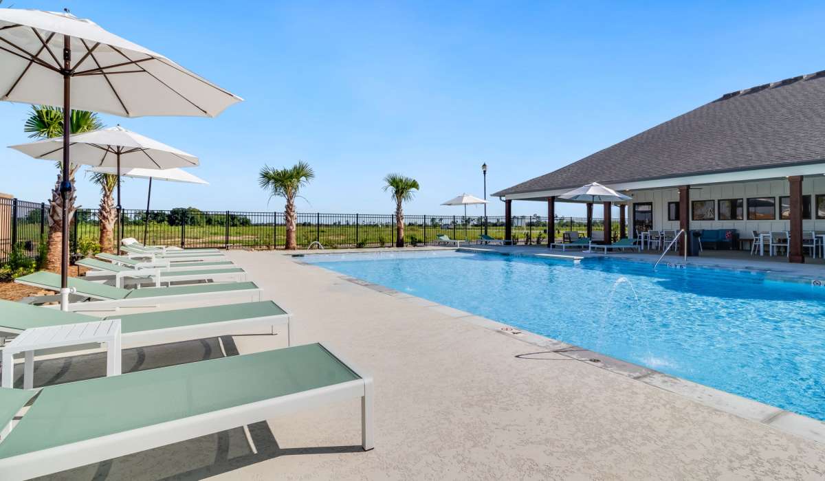 Swimming pool and lounge chairs at Cottages at Sugar Mill Pond in Youngsville, Louisiana