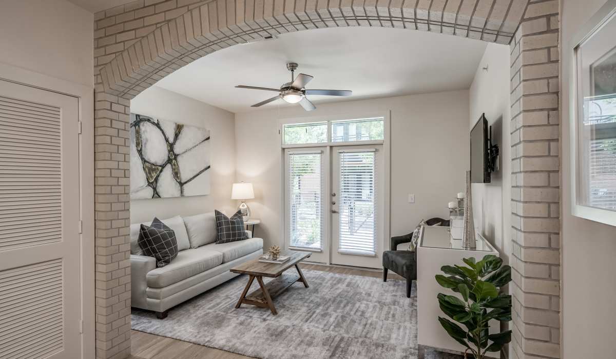 Living room with access to patio at Tate Tanglewood in Houston, Texas