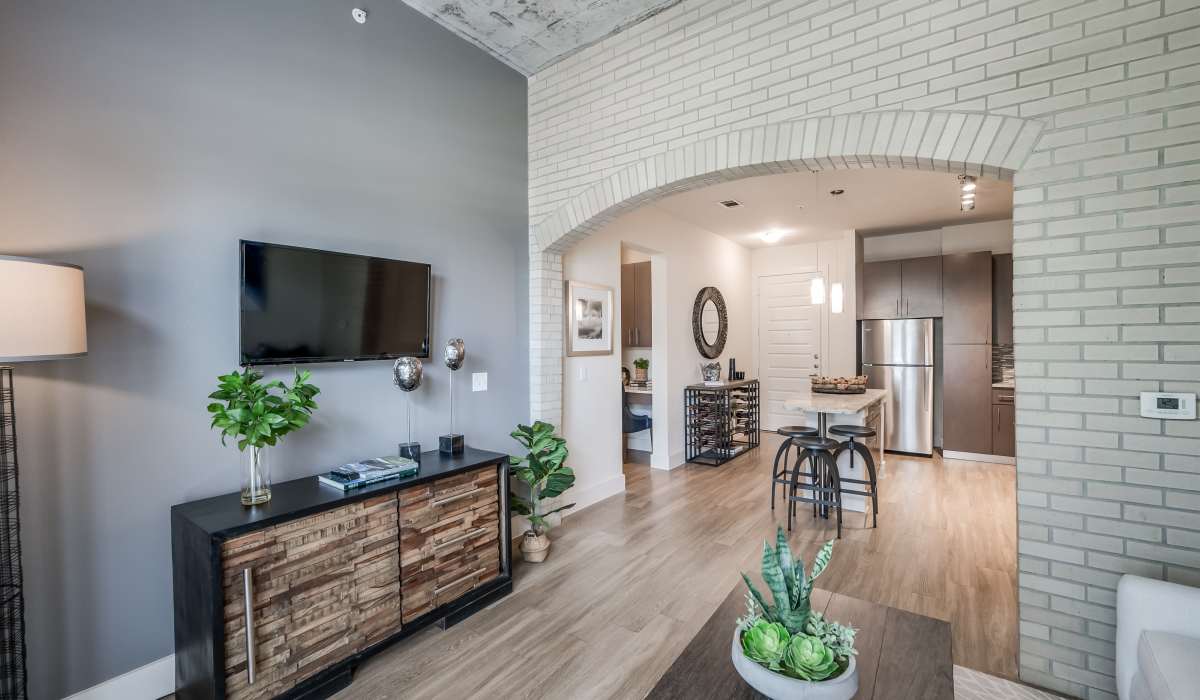 Living room with beautiful brick archway at Tate Tanglewood in Houston, Texas