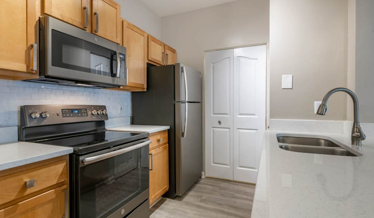 Ultra-modern kitchen with an island quartz countertops at The Legends At ChampionsGate in ChampionsGate, Florida